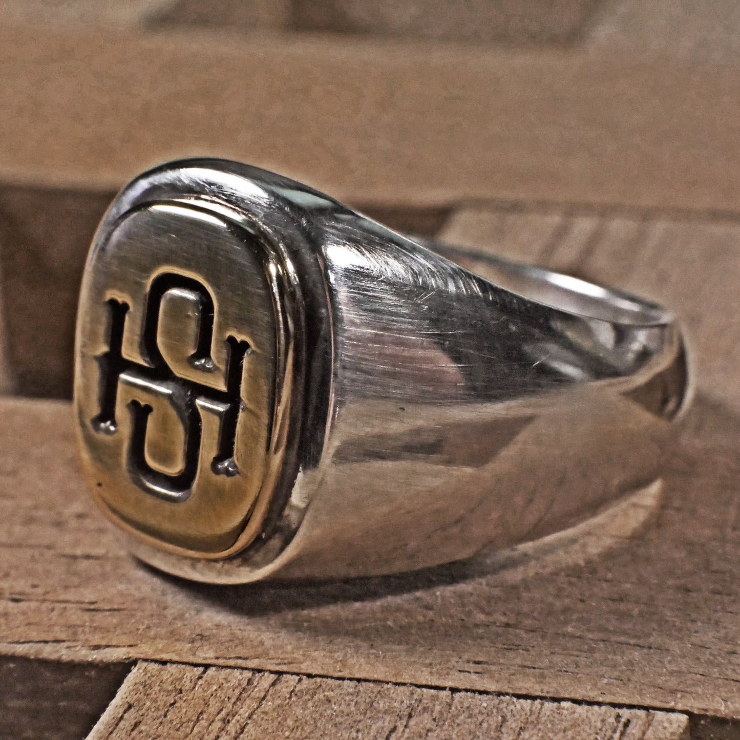 Semi polished brass face simple monogram silver ring