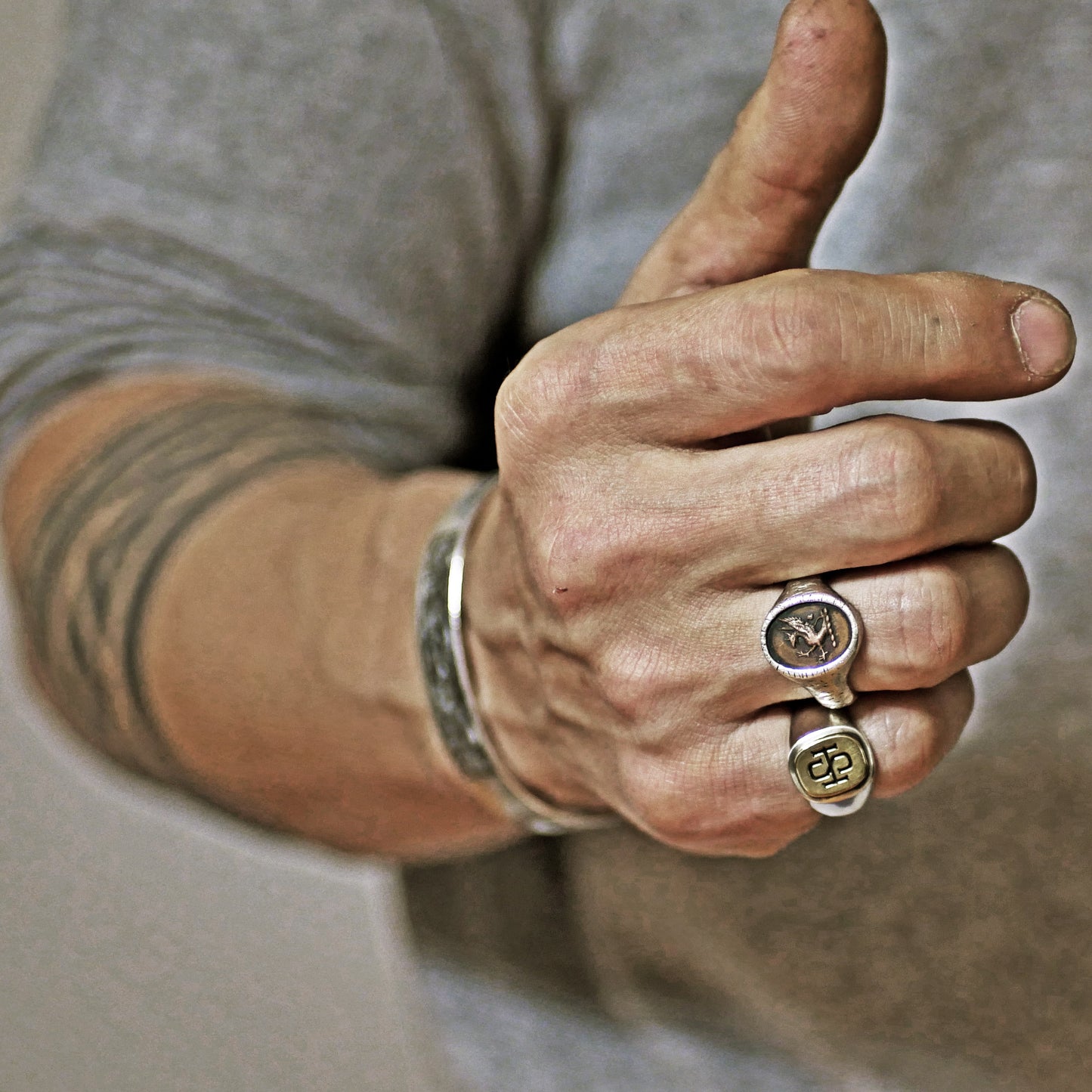 Semi polished brass face simple monogram silver ring